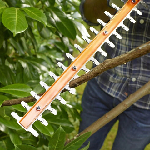 Heavy Duty Electric Hedge Trimmer With 420 Watt Motor And 45CM Cutting Blade For Fast Yard Cleanup cutting through a branch with orange blade.