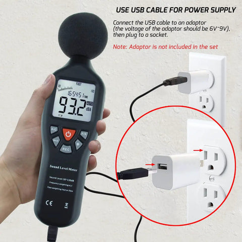Hand holding Go-To Digital Sound Level Meter With Backlit Display, measuring noise, USB cable for power, wall plug shown