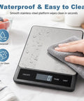 Digital Kitchen Scale With 33Lb Capacity, Waterproof Stainless Steel Surface, USB Rechargeable Power being cleaned