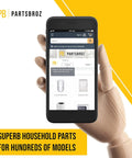 Wooden hand holding smartphone displaying PartsBroz website, showcasing appliance parts and categories, yellow background.