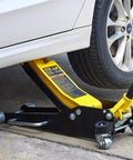 VEVOR 3-ton low-profile floor jack, yellow and black, side view under a car