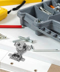 Concealed Cabinet Door Hinges With Soft Close And Hydraulic Buffer For Inward Opening Doors shown with screws and tools