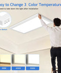 Man installing 1x2 Ft LED Flat Panel Light Flush Mount, Dimmable Surface Mount Ceiling Fixture with adjustable color temperatures.