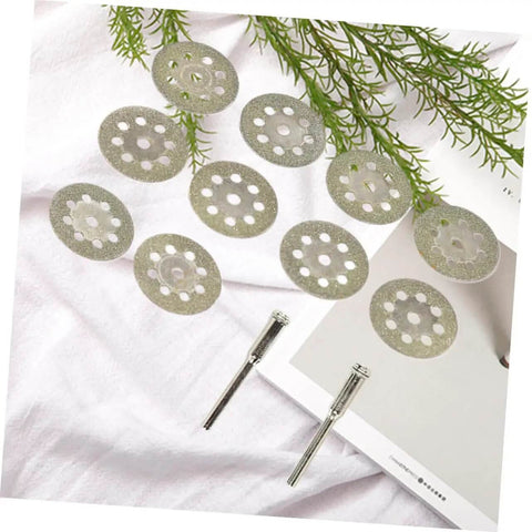 Ten Piece Diamond Cutting Discs Set For Rotary Tools with two metal rods and ultrathin blades on a white surface.