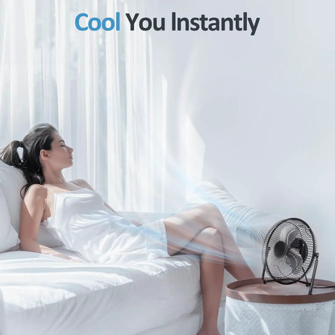 Woman relaxing beside Three Speed Portable Metal Floor Fan With Adjustable Tilt For Home Office And Bedroom Quiet Operation Lightweight Yet Sturdy Black Nine Inch Chill Breeze For Desk Or Floor Use