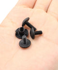 Built Different Eighty Piece Gun Holster Screw And Tri Prong T Nut Kit With 8-32 Threads, black screws in hand.
