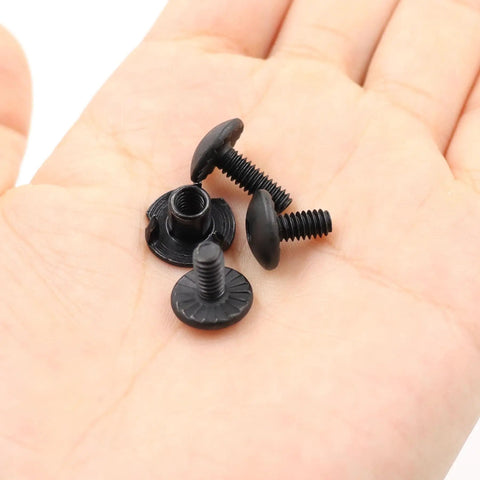 Built Different Eighty Piece Gun Holster Screw And Tri Prong T Nut Kit With 8-32 Threads, black screws in hand.