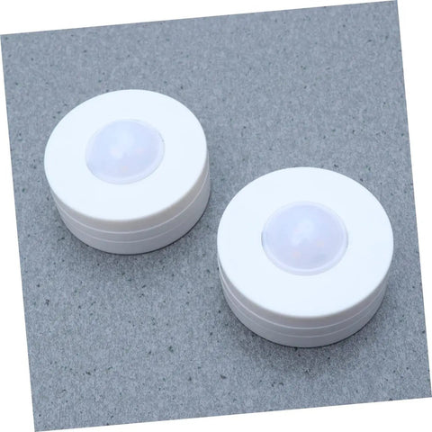 Two round lights from the Six Pack LED Cabinet Lights Set With Dimmable Warm White Under Cabinet Lighting For Cupboards Kitchen And Office Use.