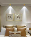 4.5 Inch Brass Downlight With Cob Recessed Lighting Kit And Six To Fourteen Watt Options For Zero Hassle Corridor Or Living Room Ceiling Install That Delivers Straight Up Brilliant Glow Indoors illuminating a modern bedroom with artwork.