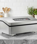 Stainless steel kitchen appliance on marble counter with self adhesive caster wheels for easy mobility.