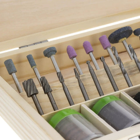 Close-up of 228 Piece Deluxe Universal Rotary Tool Accessory Kit with drill bits and abrasive wheels in wooden case