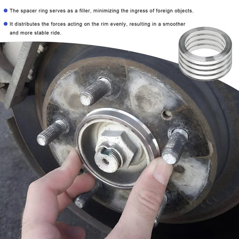 Installation of Four Pack Hub Centric Rings 56 To 73 Mm Wheel Center Bore Adapters on a car wheel for stability.