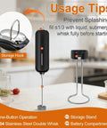 Handheld Milk Frother With Double Whisk Battery Operated Electric Foam Maker on counter with black stand and storage hook