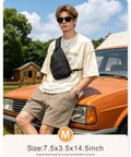 Model wearing Everyday Crossbody Bag For Men And Women With Convertible Shoulder Strap, outdoors, size M, black, on orange car