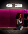 Woman adjusting Hue LightStrip Plus Dimmable LED Smart Light Extension for Ambient Mood Lighting in kitchen with Alexa, Google Assistant.