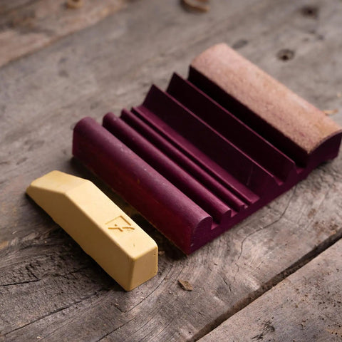 Wood Carving Tools SlipStrop Kit For Razor Sharp Edges And Ultra Smoothing Deburring And Polishing Compound Included Works On Gouges V Tools U Gouges PW12 Made In USA showing strop and compound on wood table.