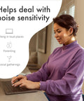 Woman wearing ClearTone High Fidelity Ear Plugs for Concerts and Noise Sensitivity 21dB Reduction, using laptop at home.