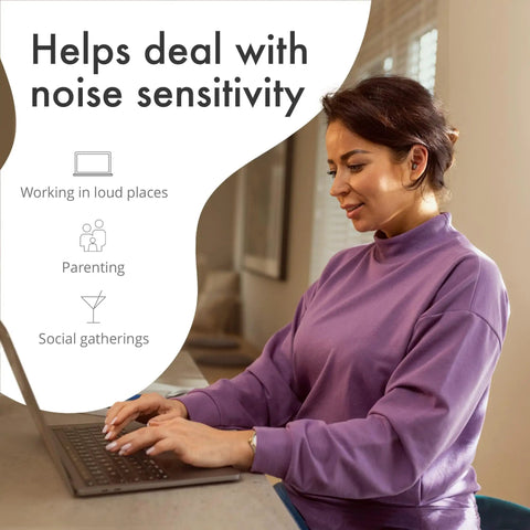 Woman wearing ClearTone High Fidelity Ear Plugs for Concerts and Noise Sensitivity 21dB Reduction, using laptop at home.