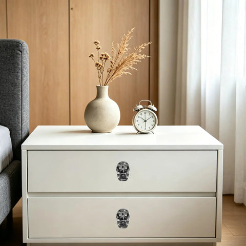 Sick Badass Crystal Skull Drawer Knobs Four Pack Heavy Duty Glass Cabinet Pulls Handle Gray Gothic Statement Piece For Dresser And Halloween Decor on white nightstand with vase and clock.
