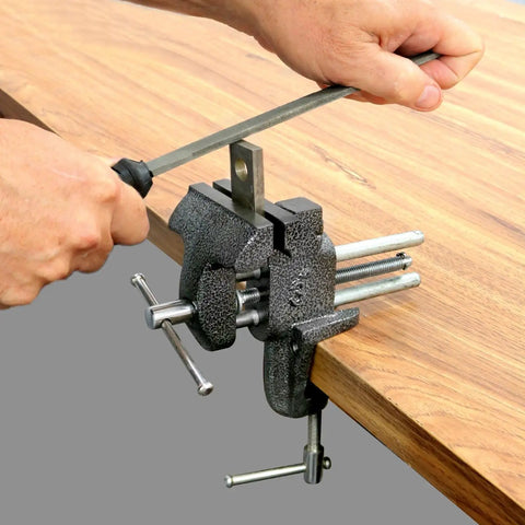 Heavy Duty Workshop Clamp Vise With 3 Inch Jaw, 20000 PSI Castings, Replaceable Hardened Steel Jaws, Compact Benchtop Design, Chrome Plated Handle And Base, Powder Coated Finish For Durable Portable Crafting clamped to a wooden bench