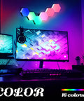 Remote Control Hexagon Wall Light Kit Smart Wall Mounted Touch Sensitive Geometric Modular RGB LED Panels DIY Colorful Light System With USB Power Includes 10 Pack For Bedroom Vibes mounted above a desk with computer monitors displaying colorful graphics.