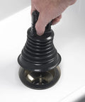 Hand using Must Have Mini Bellows Sink Plunger For Kitchens Bathrooms Baths Laundry Tubs And RVs Compact Powerful Clog Clearing Tool