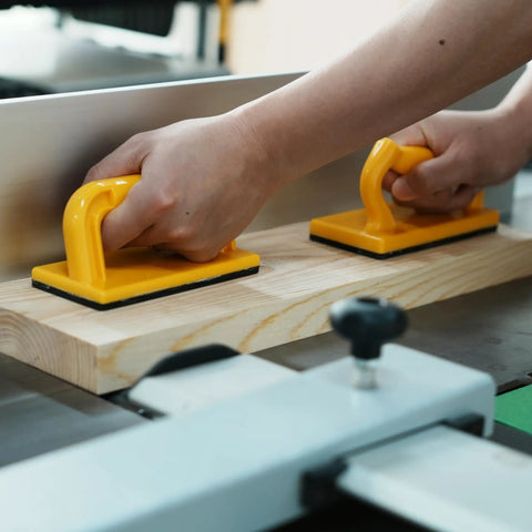 Hands using Heavy Duty Push Block And Push Stick Set For Table Saws Router Tables Band Saws on wood for safer cutting.