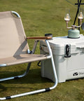 Dtacke cooler front view with rubber T-handle latches (160mm); white cooler with two front latches beside camping chair
