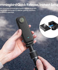 Person holding Invisible Quick Release Selfie Stick Motorcycle Mount Kit with 40 inch adjustable pole and camera attached.