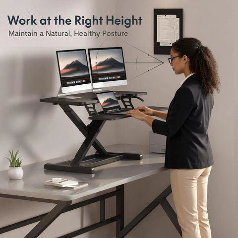 Person using 36 Inch Standing Desk Converter Riser With Smooth Spring Lift System For Sit Stand Workstation
