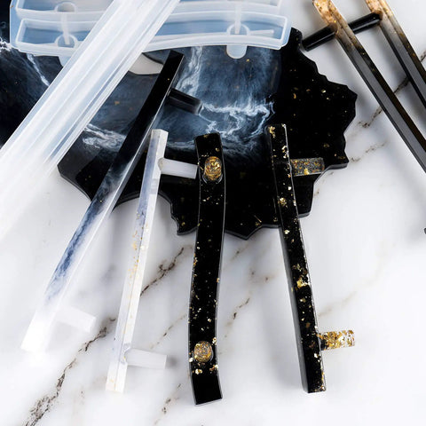 Top Shelf Four Pair Epoxy Resin Silicone Molds For Custom Bar Pull Handles And Cabinet Hardware showcasing clear and black molds with decorative gold accents.