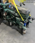 Industrial engine hoisted by 6 Ft Long By 2 In Wide Tow Strap With Reinforced Eyes, Heavy Duty Vehicle Recovery Rope, in shop setting.