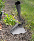 Triangle Hoe Digger Garden Tool Set For Weeding, Planting, And Ditch Digging in garden soil, focus on iron head.