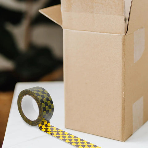 Plaid Pattern Shipping Tape 2 Rolls Adhesive Sealing Packing Tape With Black Yellow Grid Design For Small Business Mailing And Packaging Supplies Awesome For Crating Boxes Shipping Labeling And DIY Projects At Home Or Office next to open cardboard box