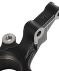 Close-up of front steering knuckle for Sentra 2000-2006 showing metal construction, part of wheel bearing hub assembly