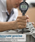 ALLmeter dial bore gauge with digital readout for engine cylinder bore; black handle, close-up view in block.