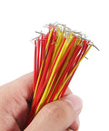 Hand holding red and yellow jumper wires from 560 Piece Jumper Wire Kit With 14 Lengths For Breadboard Prototyping And Arduino Projects