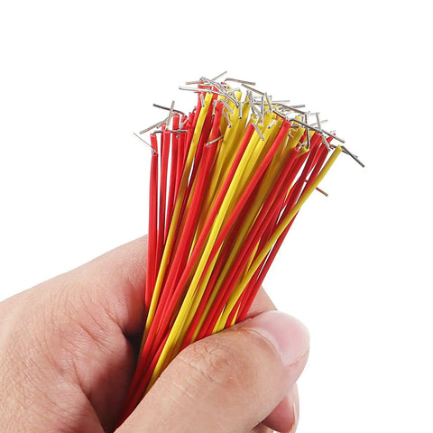 Hand holding red and yellow jumper wires from 560 Piece Jumper Wire Kit With 14 Lengths For Breadboard Prototyping And Arduino Projects