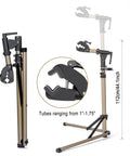 Heavy Duty Bike Repair Stand with 360 Degree Rotating Clamp holds 1 to 1.75 in tubes, shown with adjustable height and folding legs.