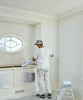 Painter using Advanced Masking Film For Indoor Outdoor Painting, 8 Rolls, 72 Inches By 90 Feet, Static Cling Keeps Film In Place on wall