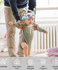 Toddler wearing a Breathable Baby Helmet For Crawling And Walking with dinosaur design, assisted by an adult, showcasing adjustable fit.