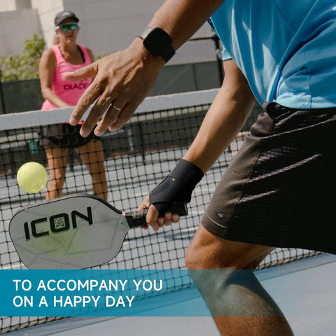 Person playing pickleball wearing Ultra Thin Pickleball And Tennis Wrist Brace For Pain Relief, black, breathable support.