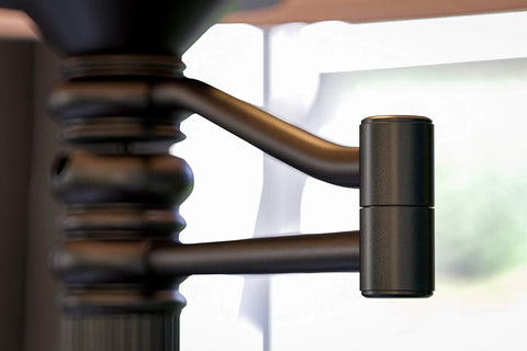 Close-up of Riverside Copper Bronze Swing Arm Floor Lamp 24-inch adjustable arm detail against blurred background.