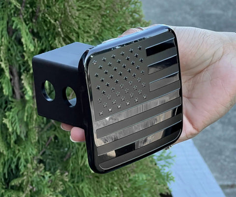 2 Inch Trailer Hitch Cover Plug With Metal American Black Flag Universal Fit For Any 2 Inch Hitch Receiver Keeps Water Dirt And Debris Out And Gives Your Ride A Rugged Look held by hand outdoors.