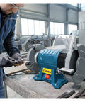 Heavy Lifter Dual Wheel Bench Grinder With Rock Solid Stability For Deburring Sharpening Steel And Aluminum Shop Grade Vertical Tool With 600 Watt Motor in use on a workbench.