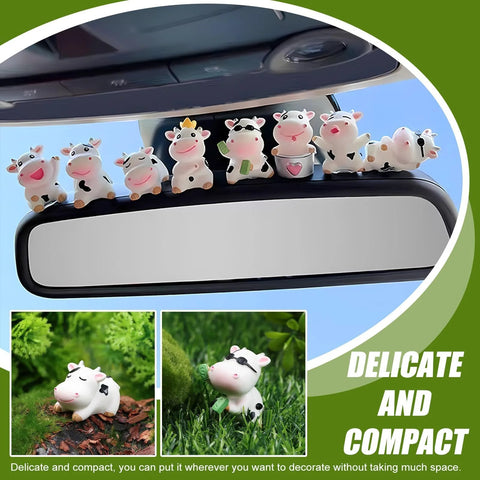 Eight white cow-shaped car dashboard ornaments with black spots perched on a rearview mirror.