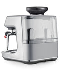 Certified Remanufactured Automatic Espresso Machine With Built In Grinder And Steam Wand Knocking Out Next Level Cafe Brews At Home, sleek silver design with transparent water reservoir.
