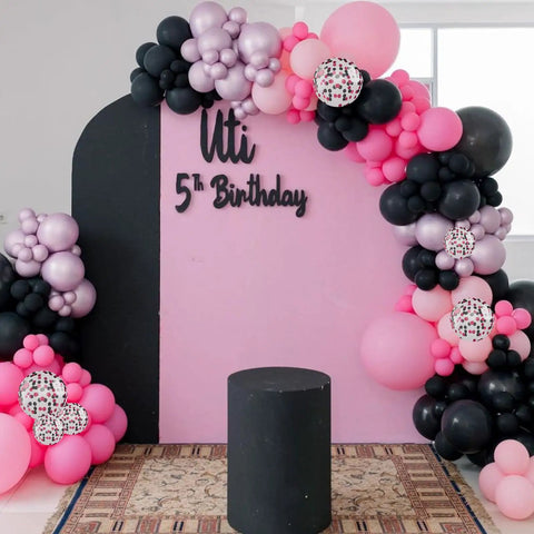 Hot Pink And Black Balloons Set 60 Count With Confetti displayed at a child's 5th birthday party on a decorative backdrop