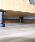 Close-up of 12 Pack Black Cabinet Leveler Legs Adjustable Furniture Feet Elevate Cabinets From Three And Seven Eighths Inches To Five And One Eighth Inches