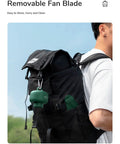 Portable Camping Fan With 8000mAh Battery And USB Rechargeable hanging on backpack, detachable blades visible in pocket